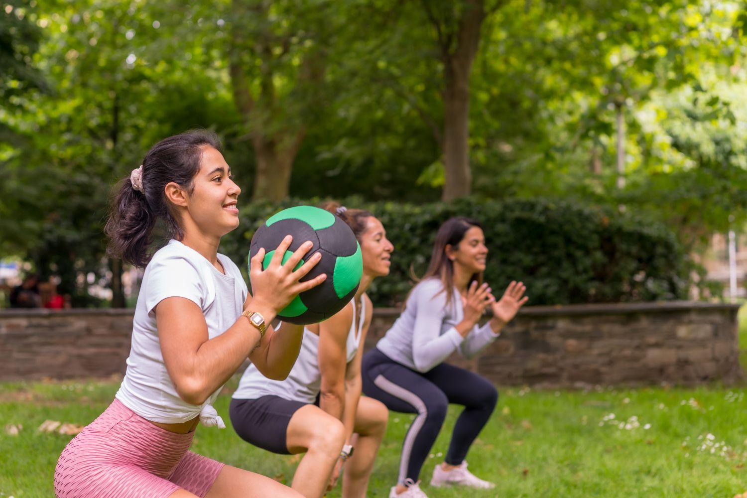 group of women exercising in the park